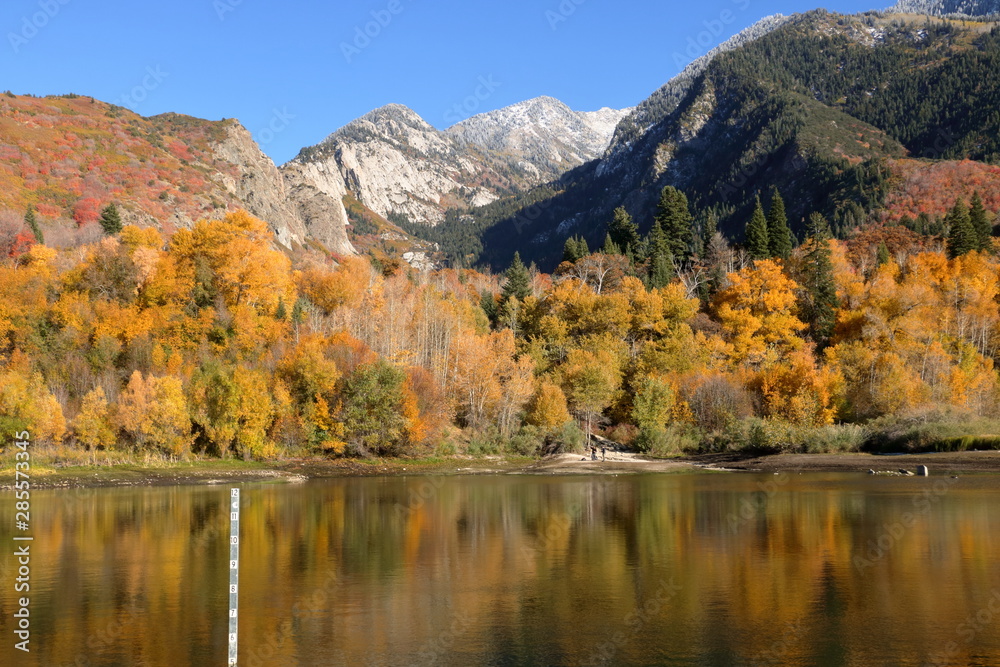 Snowcapped Wasatch Mountains and peak fall foliage at Bells Canyon Reservoir, Sandy, Utah