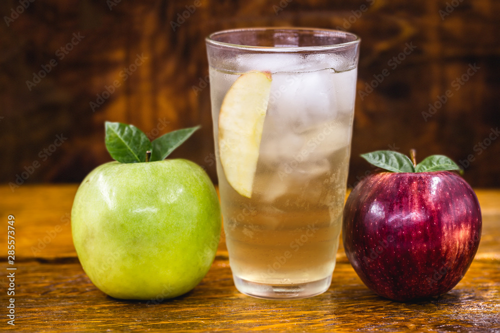 Apple spritzer (apfelschorle) pitcher, Glass pitcher of homemade spritzer served with crushed ice and apple slices. Jug full of non-alcoholic sparkling and cold carbonated apple juice. Apple spritzer (apfelschorle) pitcher, Glass pitcher of homemade spritzer served with crushed ice and apple slices. Jug full of non-alcoholic sparkling and cold carbonated apple juice.