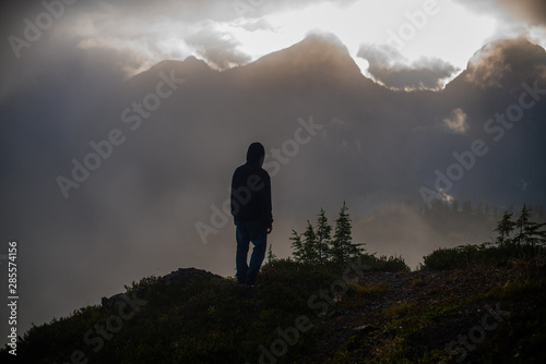 silhouette of man on top of mountain