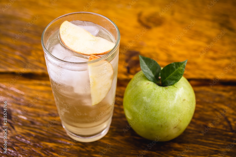 Apple spritzer (apfelschorle) pitcher, Glass pitcher of homemade spritzer served with crushed ice and apple slices. Jug full of non-alcoholic sparkling and cold carbonated apple juice. Apple spritzer (apfelschorle) pitcher, Glass pitcher of homemade spritzer served with crushed ice and apple slices. Jug full of non-alcoholic sparkling and cold carbonated apple juice.