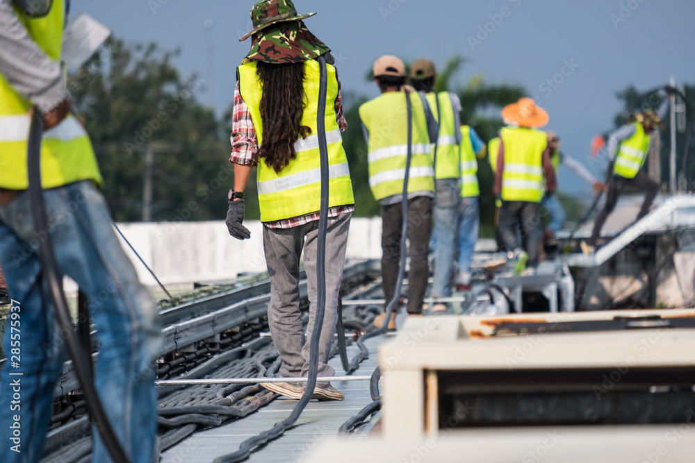 Workers are moving cables in construction sites.