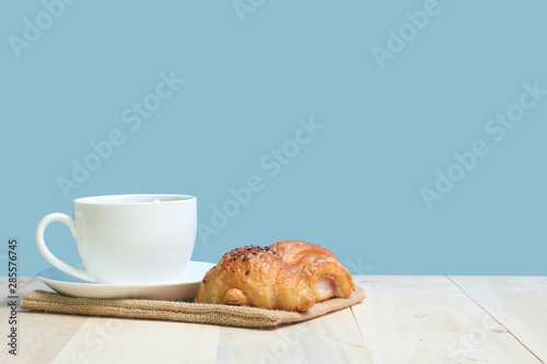Croissant and coffee   on wood table