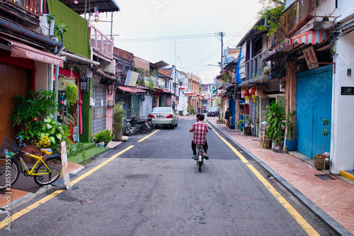 man on a bicycle  in a street of Malacca, Malaysia  © littleTravel Moments