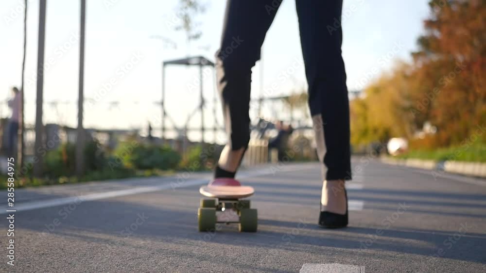 Girl businessman rides on a skateboard in stilettos. HD, 1920x1080, slow motion Girl businessman rides on a skateboard in stilettos. HD, 1920x1080, slow motion