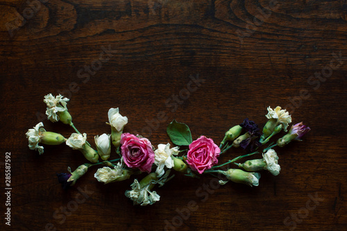 Flowers Composition on a wood table, Greeting card, Rose and carnation composition, Close up shot, Flat lay, top view, copy space.