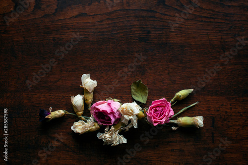 Flowers Composition on a wood table, Greeting card, Rose and carnation composition, Close up shot, Flat lay, top view, copy space.