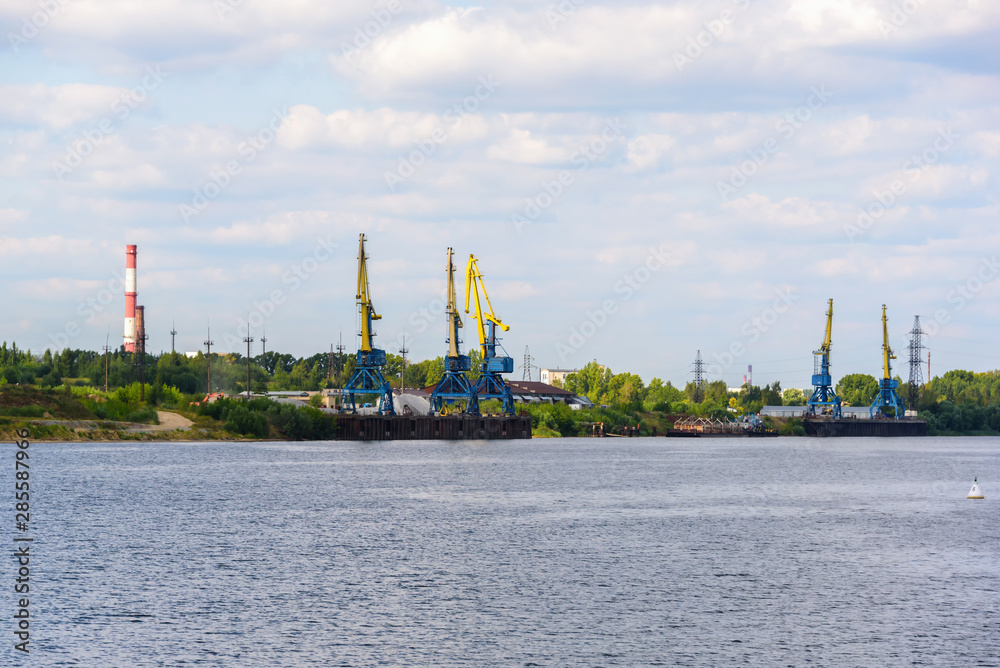Russia, Moscow August 2018: Unloading of the barge with crushed stone port cranes in the port.
