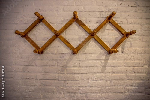 The background of the clothes hanger is made of wood and placed on the wall, for ease of use.