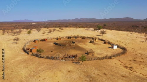 Beautiful aerial over a round Himba African tribal settlement and family compound in northern Namibia, Africa. photo