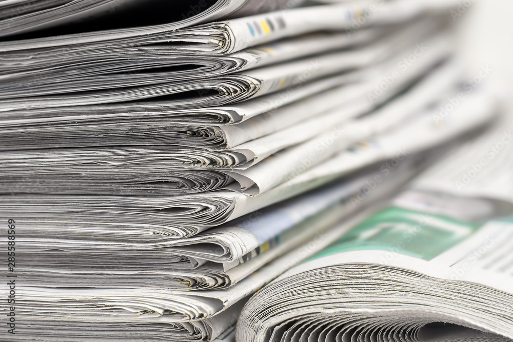 A stack of folded newspapers on the desktop in the office. Latest financial and business news in daily paper. A stack of folded newspapers on the desktop in the office. Latest financial and business news in daily paper.