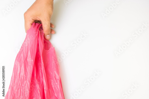 Hand holding empty, clean Shot on white background.Plastic bag