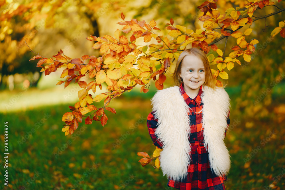 young beautiful little stylish girl in a sunny autumn park young beautiful little stylish girl in a sunny autumn park