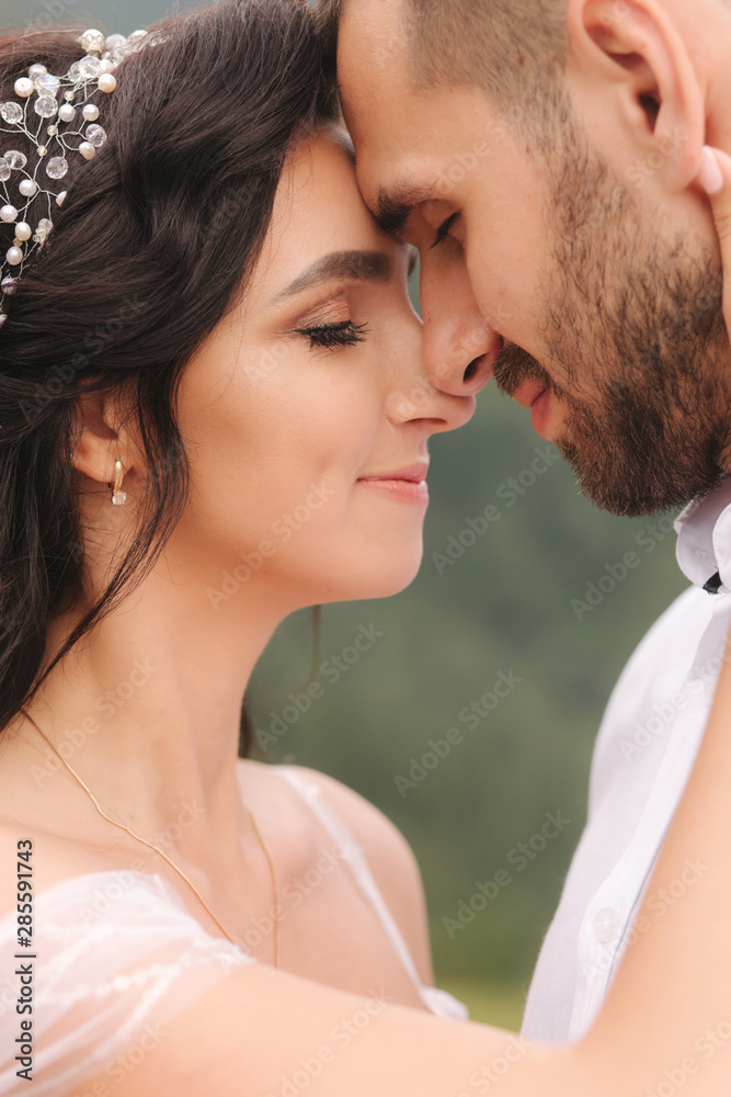 Close up portrait of beautiful couple in mountains. Happy woman with man. Elegant female with her husband Close up portrait of beautiful couple in mountains. Happy woman with man. Elegant female with her husband