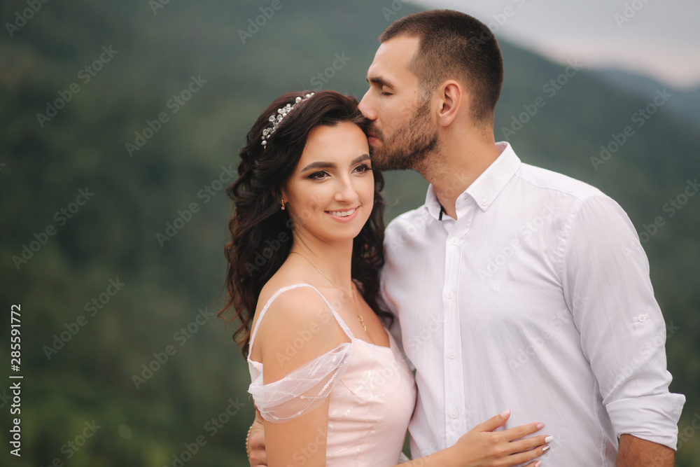 Close up portrait of beautiful couple in mountains. Happy woman with man. Elegant female with her husband Close up portrait of beautiful couple in mountains. Happy woman with man. Elegant female with her husband
