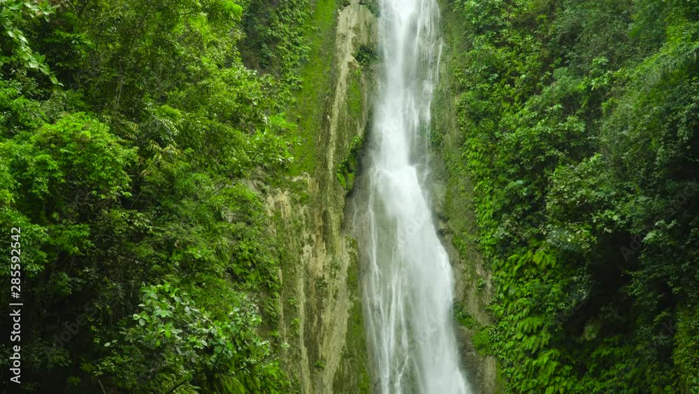 Beautiful waterfall in green forest. Tropical Mantayupan Falls in mountain jungle, Philippines, Cebu. Waterfall in the tropical forest. Beautiful waterfall in green forest. Tropical Mantayupan Falls in mountain jungle, Philippines, Cebu. Waterfall in the tropical forest.