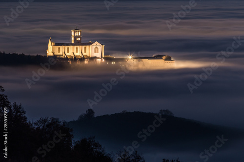 View of St.Francis church (Assisi, Umbria) at night, over a sea of fog