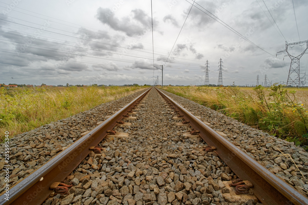 Railway line in France, ground perspective view during a bad weather day