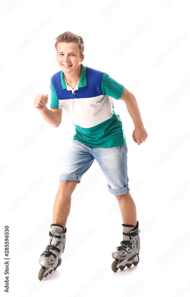 Teenage boy on roller skates against white background