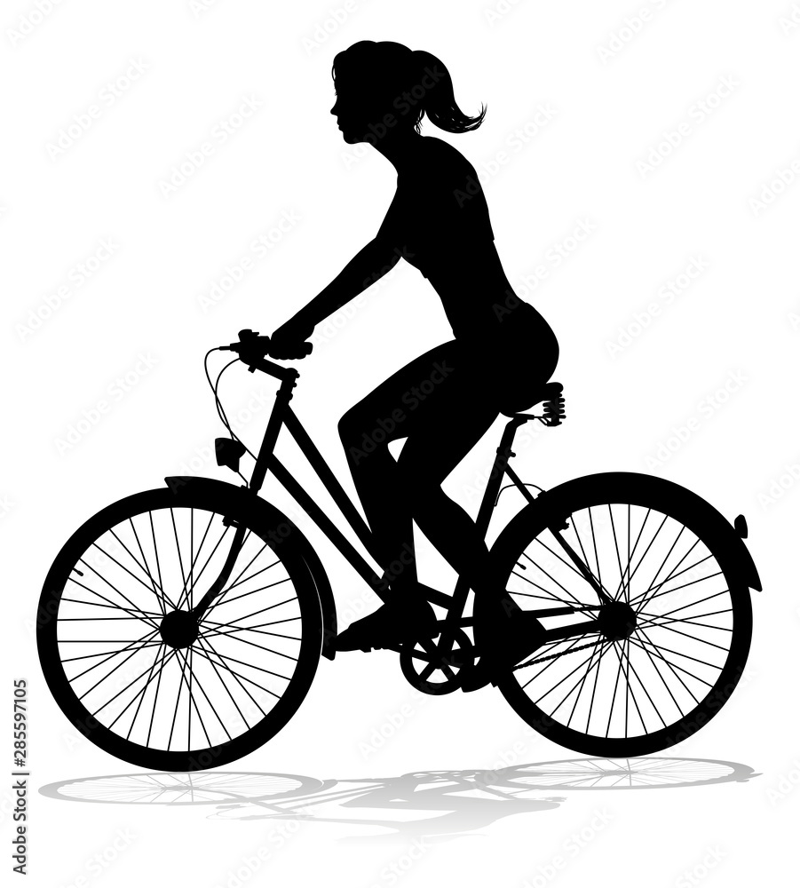 Fototapeta premium A woman bicycle riding bike cyclist in silhouette