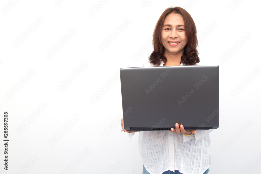Beautiful woman holding a laptop while posing against a white background Beautiful woman holding a laptop while posing against a white background