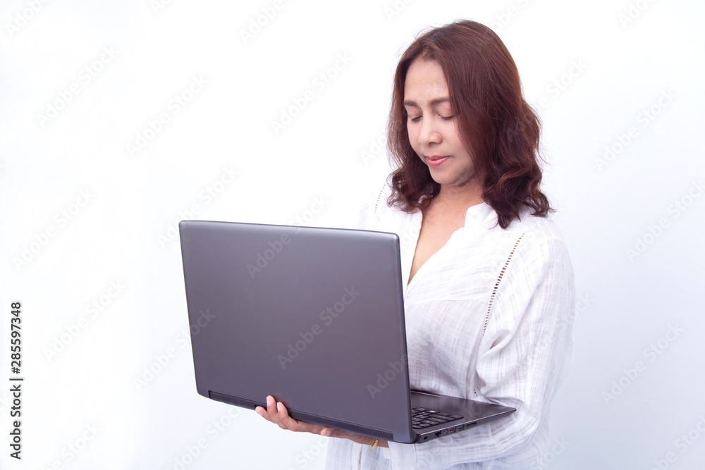 Beautiful woman holding a laptop while posing against a white background Beautiful woman holding a laptop while posing against a white background