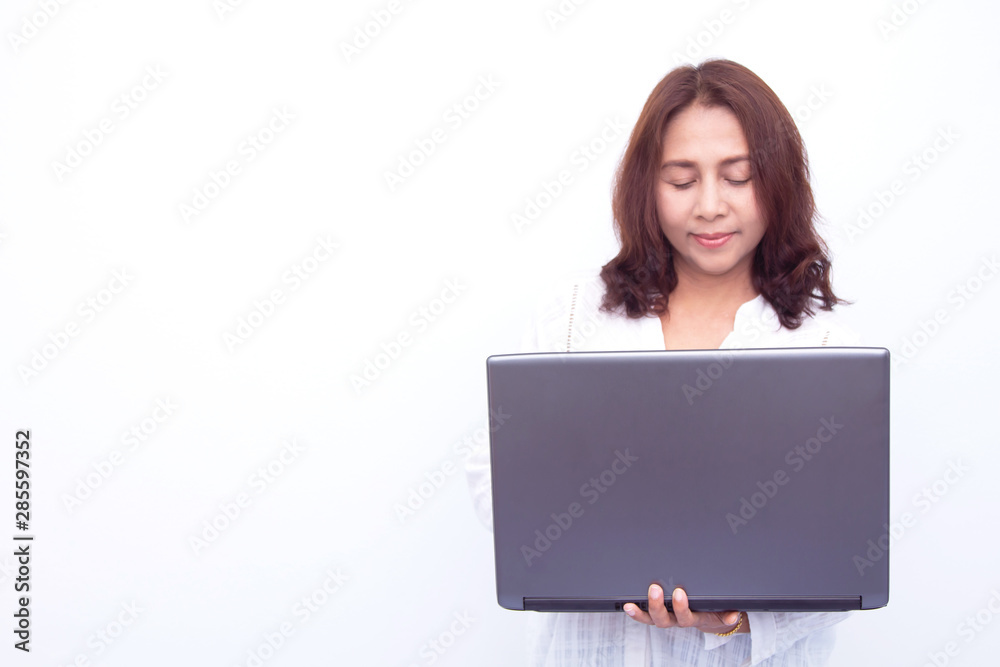 Beautiful woman holding a laptop while posing against a white background Beautiful woman holding a laptop while posing against a white background