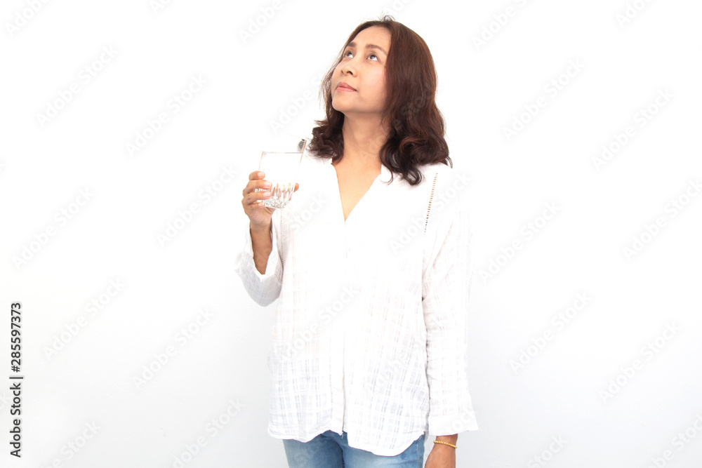 Woman holding water glass and look high. Isolated portrait on white background. Woman holding water glass and look high. Isolated portrait on white background.
