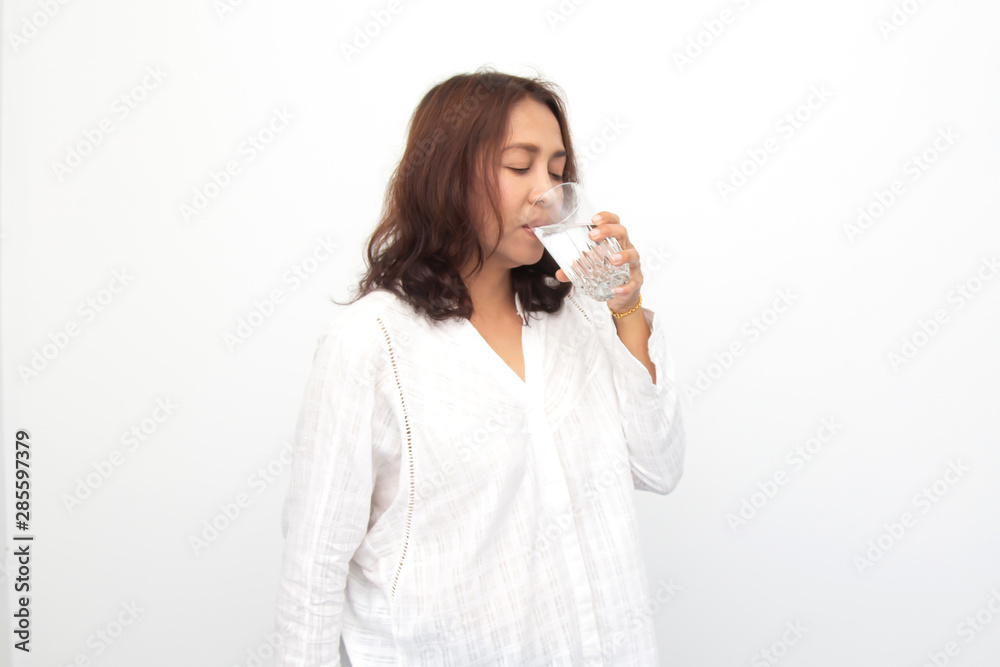 Portrait of a young woman drinking water on white background Portrait of a young woman drinking water on white background