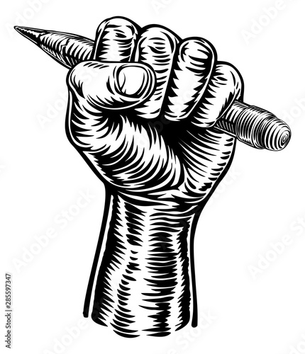 A fist hand holding a pencil in a vintage intaglio woodcut engraved or retro propaganda style