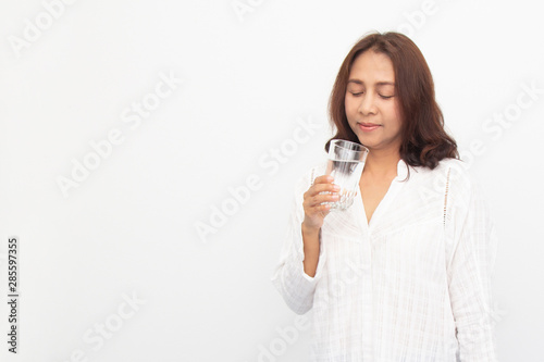 Portrait of a young woman drinking water on white background © anuwat