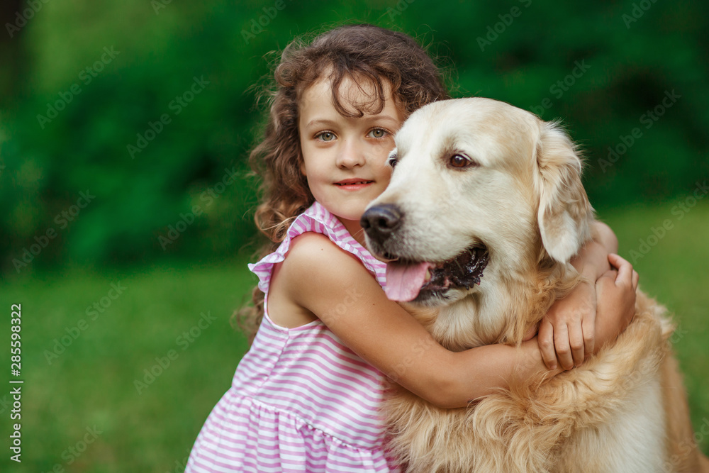 Little girl with a golden retriever, outdoor summer Little girl with a golden retriever, outdoor summer