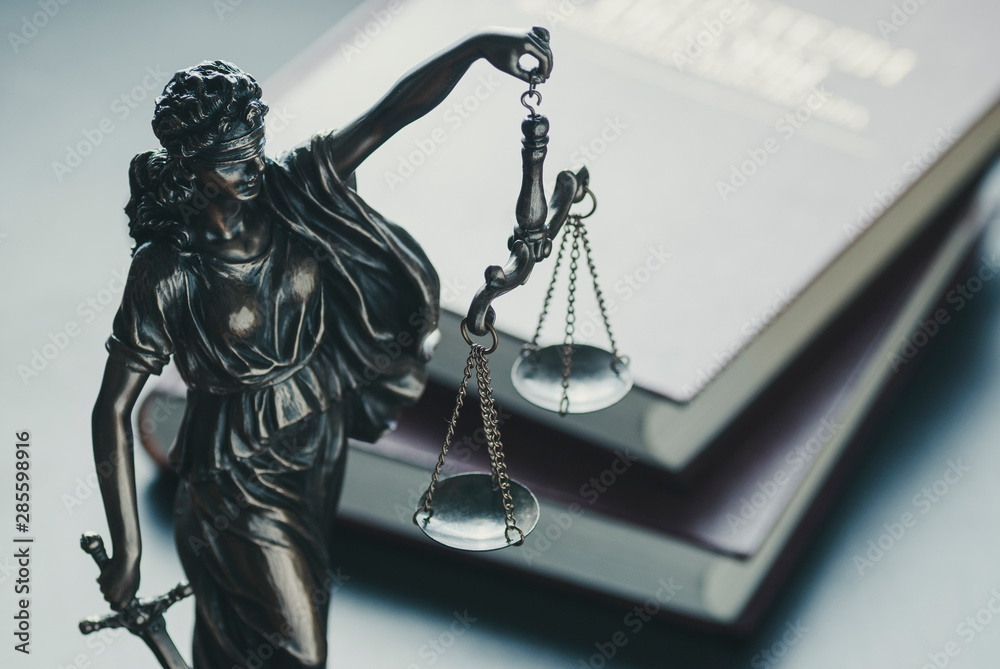 Statue of the figure of Justice holding scales