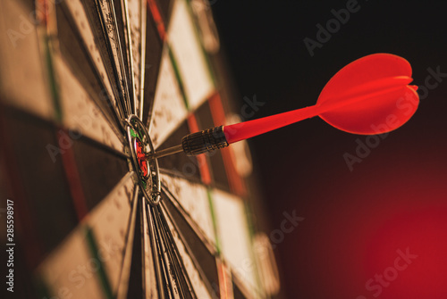 Successful bulls eye centre dart on a target