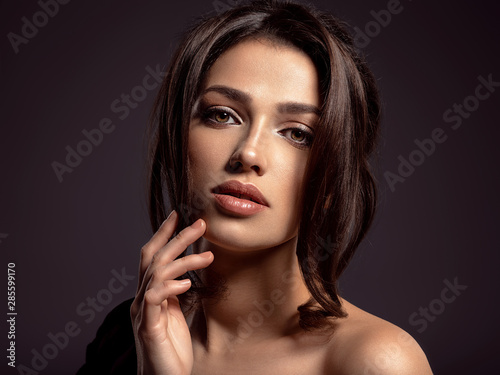 Beautiful woman with brown hair. Attractive model with brown eyes.