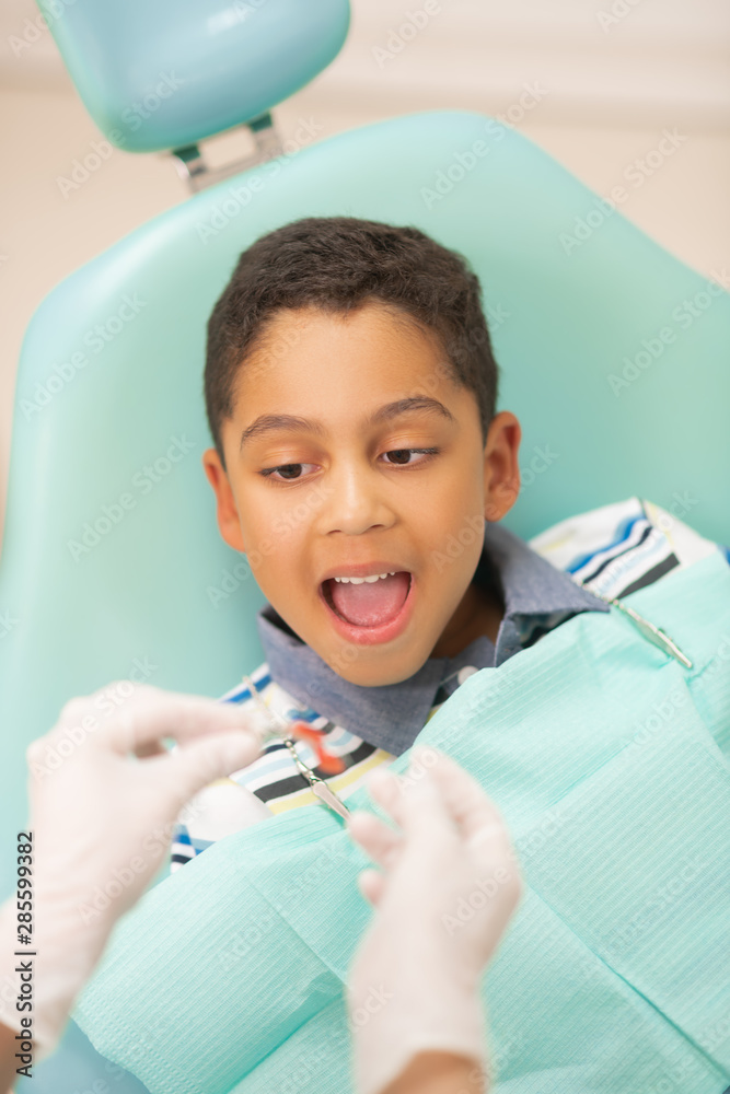 Boy opening mouth while dentist putting mouth guard Stock Photo Adobe
