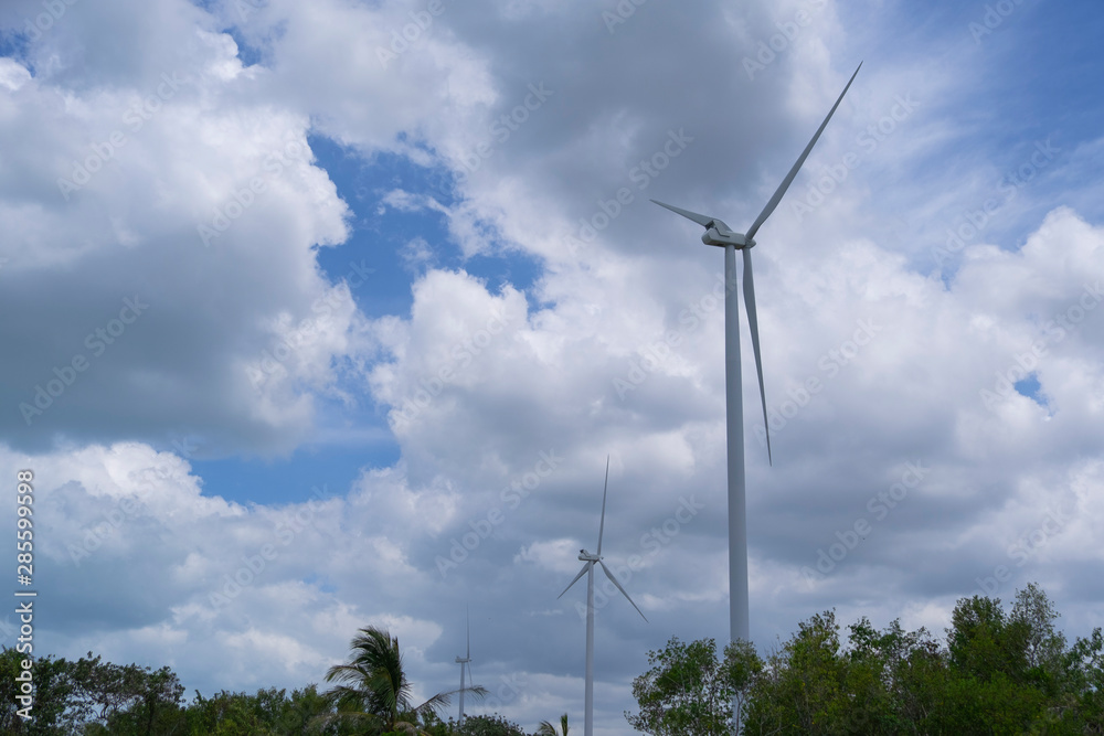Wind turbine farm to generate the electric power with blue sky and cloudy day Wind turbine farm to generate the electric power with blue sky and cloudy day