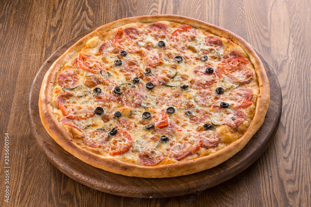 Pizza pepperoni with olives isolated on wooden background