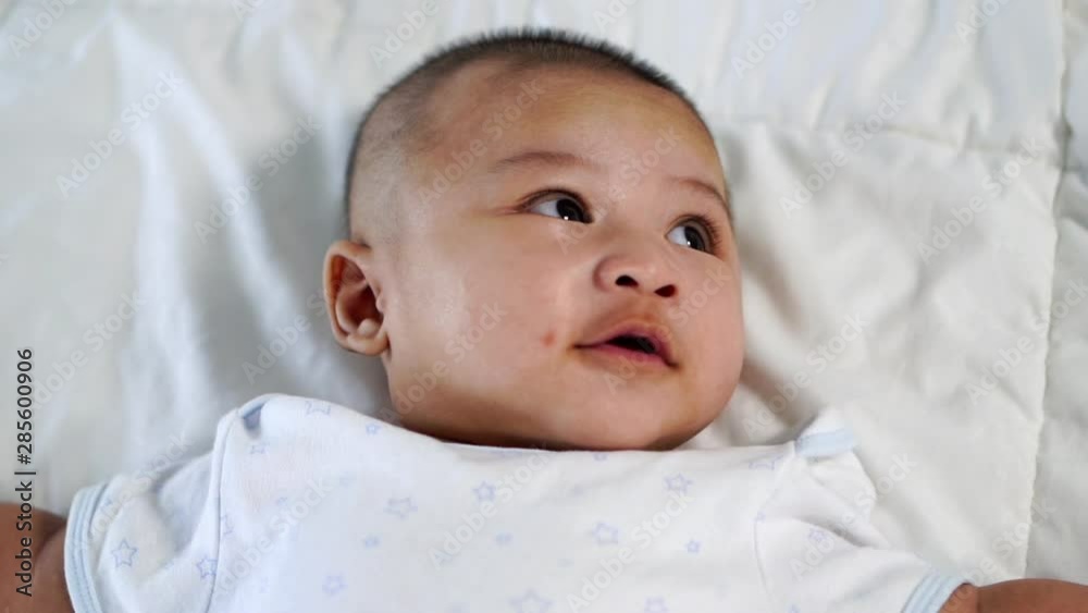 slow-motion of happy baby lying on a bed at home slow-motion of happy baby lying on a bed at home