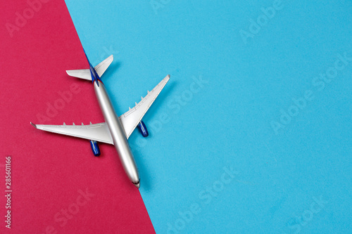 top view photo of toy airplane over color background . travel concept .
