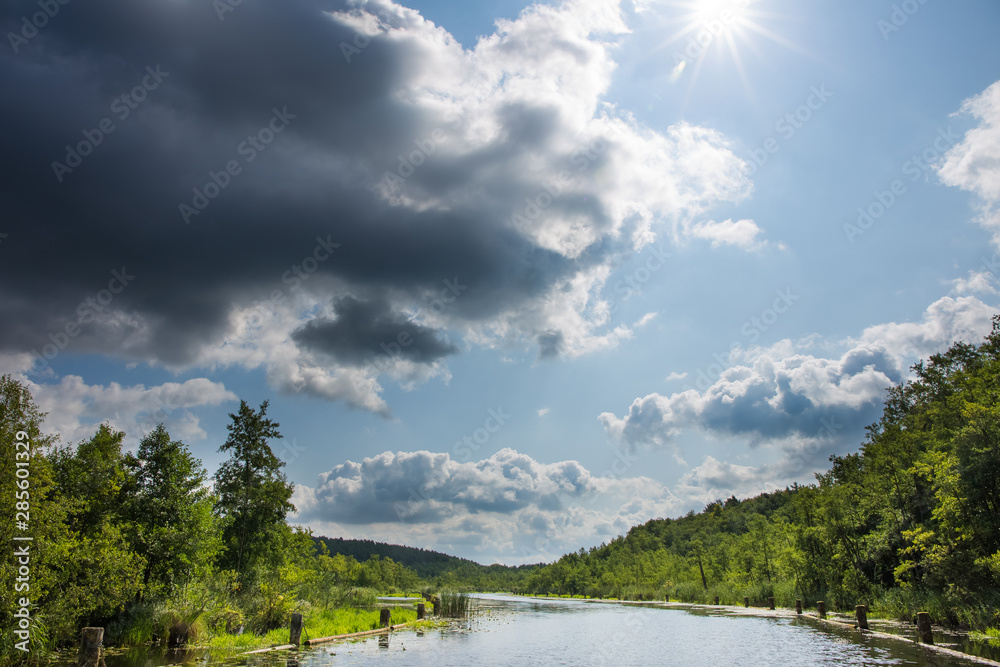 A beautiful landscape in summer in the state of Brandenburg (Germany). Nature, water, clouds and sunshine in a nature reserve. A beautiful landscape in summer in the state of Brandenburg (Germany). Nature, water, clouds and sunshine in a nature reserve.