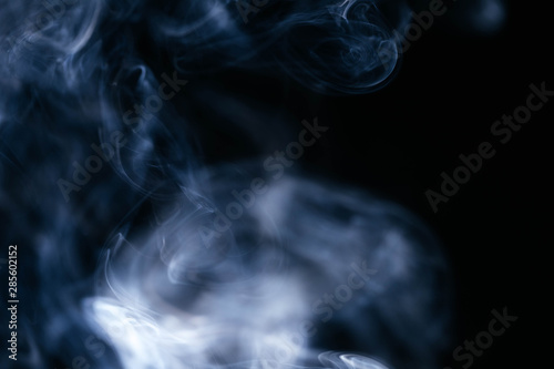 Blue wavy smoke on black background