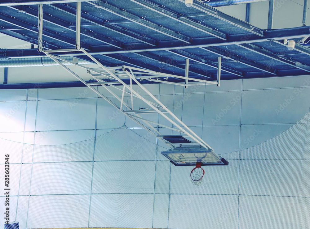 Fototapeta premium Fold orange basketball hoop with white net in indoor gym