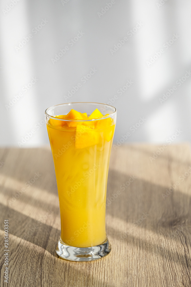 Mango Boba Bubble Milk Tea with bubble topping for tea or other beverage on the wood table with copy-space for textures and wall Natural light background Mango Boba Bubble Milk Tea with bubble topping for tea or other beverage on the wood table with copy-space for textures and wall Natural light background
