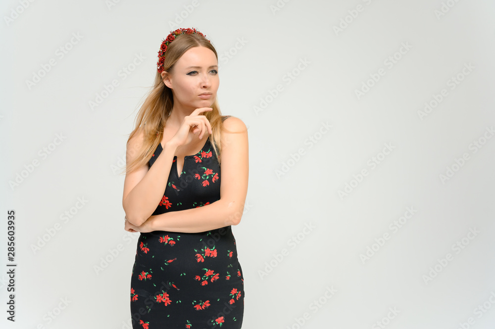 Studio portrait portrait of a pretty young happy blonde woman in a beautiful dress on a white background. He smiles, talks, shows with his hands, moves, shows emotions. Studio portrait portrait of a pretty young happy blonde woman in a beautiful dress on a white background. He smiles, talks, shows with his hands, moves, shows emotions.