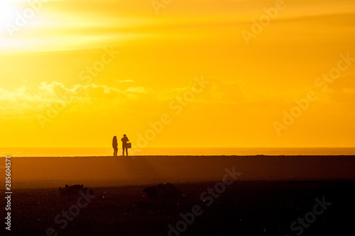 silhouette of a couple on a beach on the Oregon coast