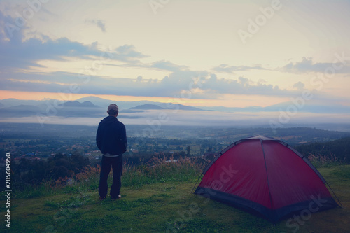 Outdoor camping tent among meadow on mountain during sunset at Yun Lai Viewpoint Pai town Mae Hong Son in Thailand. This is very popular for photographers and tourists.