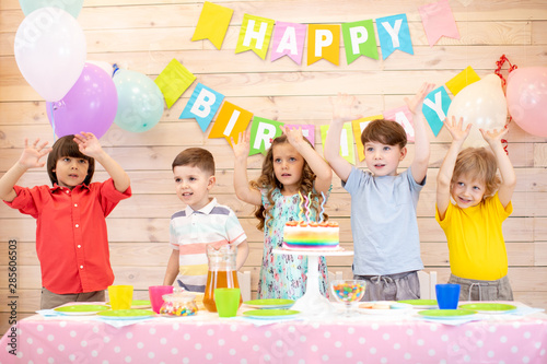 happy children at table celebrating birthday holiday
