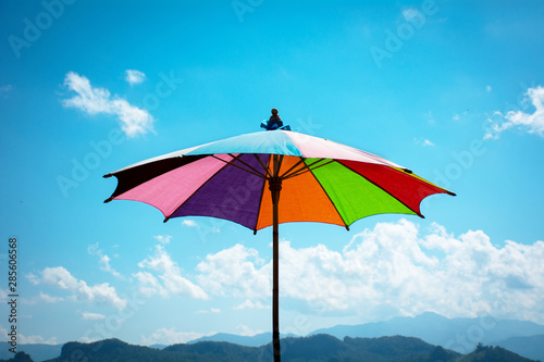 Colorful umbrella with blue sky.