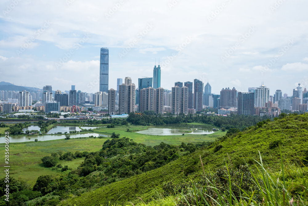 Rural green fields with fish ponds on Hong Kong and the skylines of Shenzhen Rural green fields with fish ponds on Hong Kong and the skylines of Shenzhen