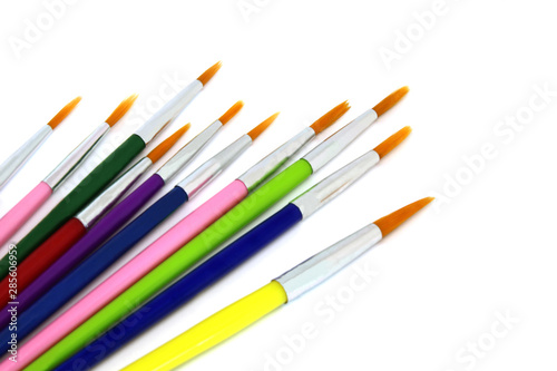 Set of colorful paint brushes on white background.
